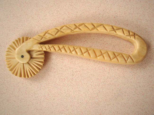 A 19th century carved walrus ivory pie crimper